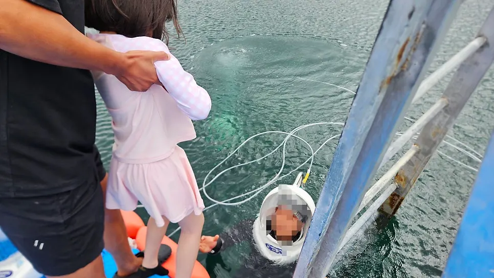 A child and instructor preparing to enter the sea