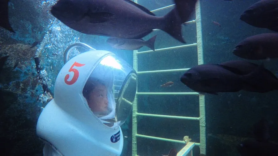 Walking the tank floor in a helmet during sea walking