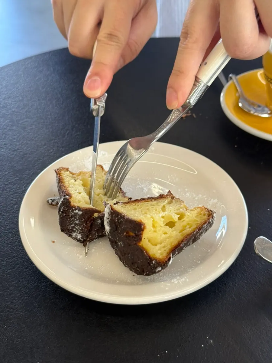 Canelé topped with con panna cream