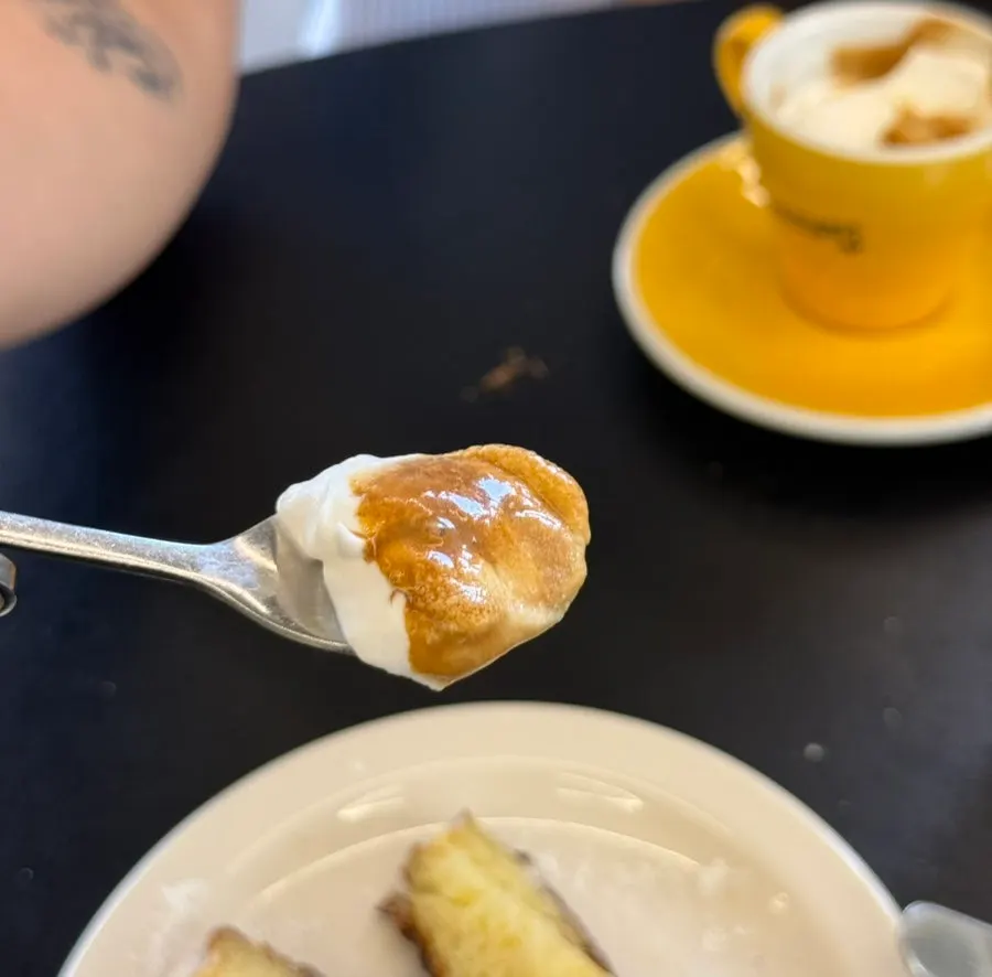 Close-up of the canelé and cream combination