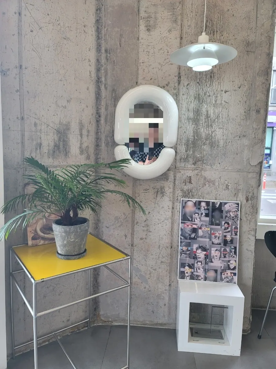 Wall with a mirror and yellow-topped table arrangement