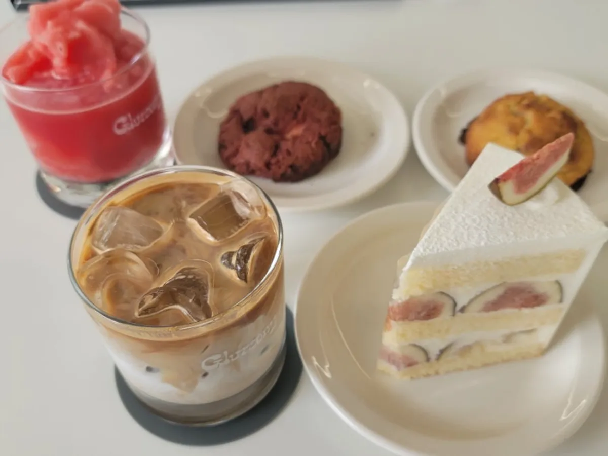 Table set with Gluttony latte, watermelon ade, and fig cake