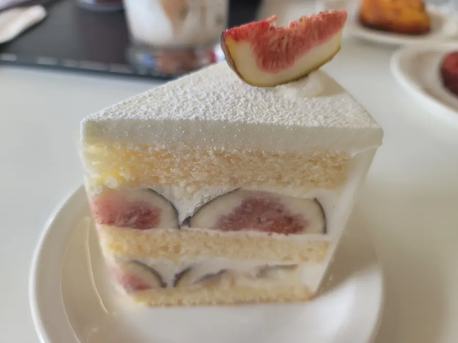 A forkful of fig cream cake lifted from the plate