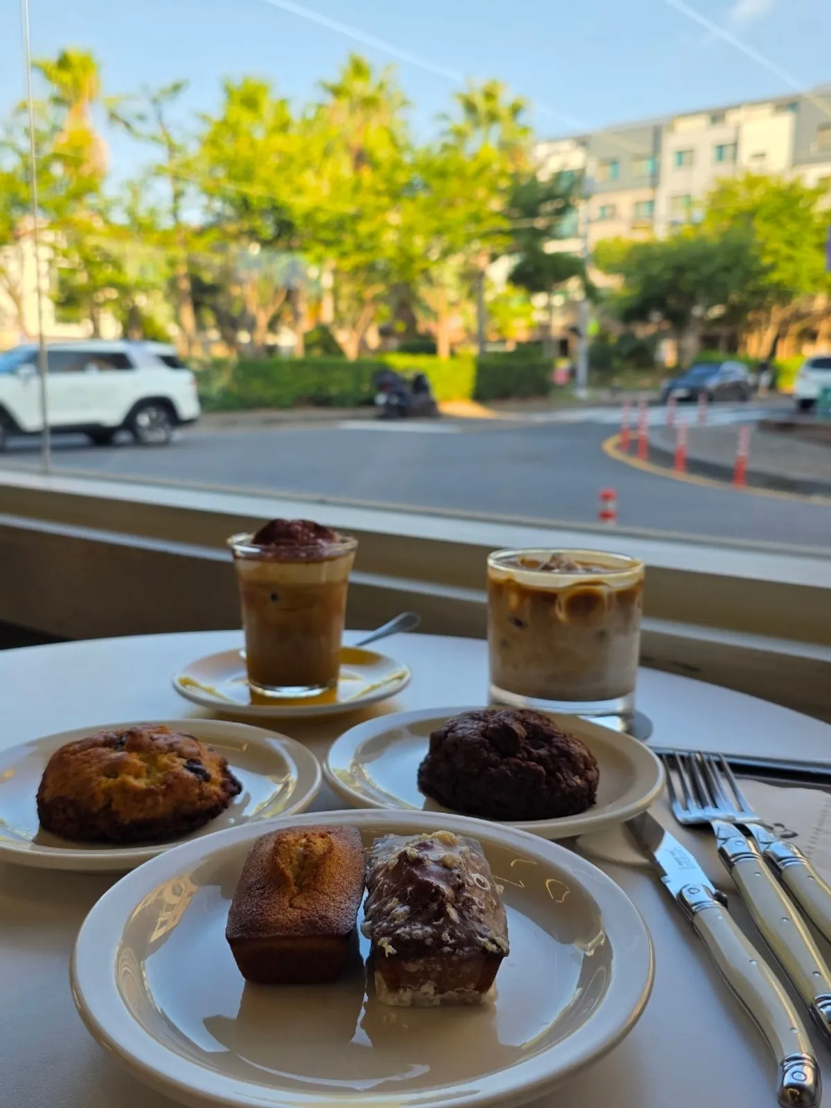 Gluttony latte and cream latte plated with financiers and levain cookies