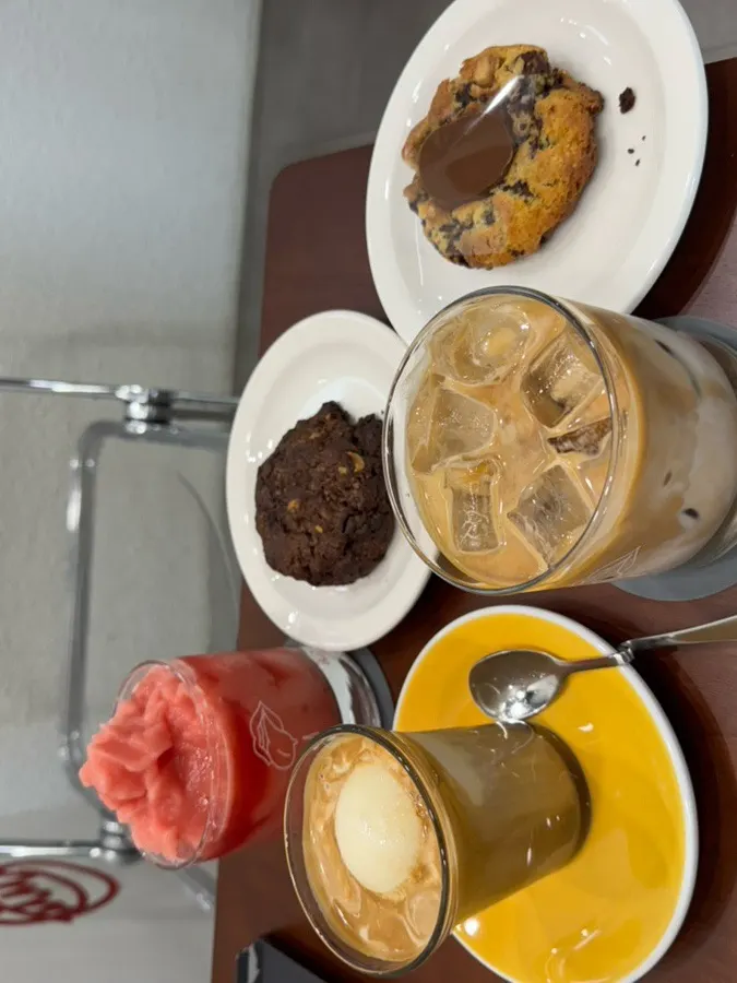 Table loaded with drinks and desserts from Gluttony Coffee