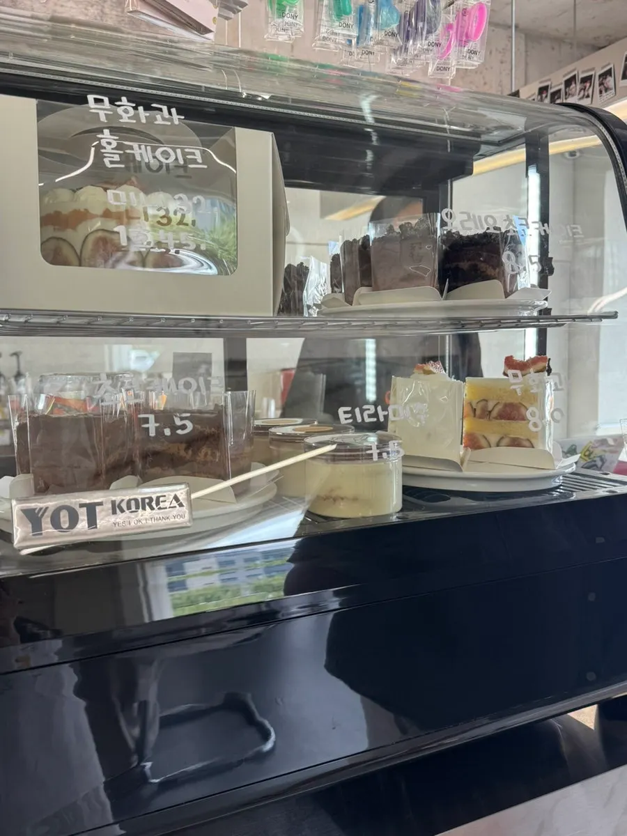 Cake and dessert display case at Gluttony Coffee