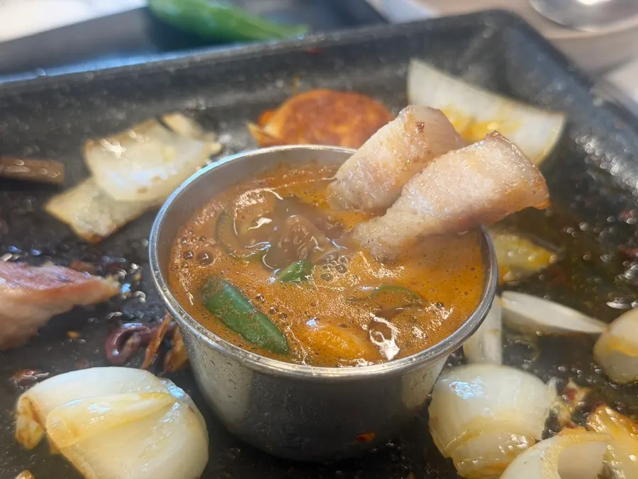 Grilled black pork served alongside meljeot