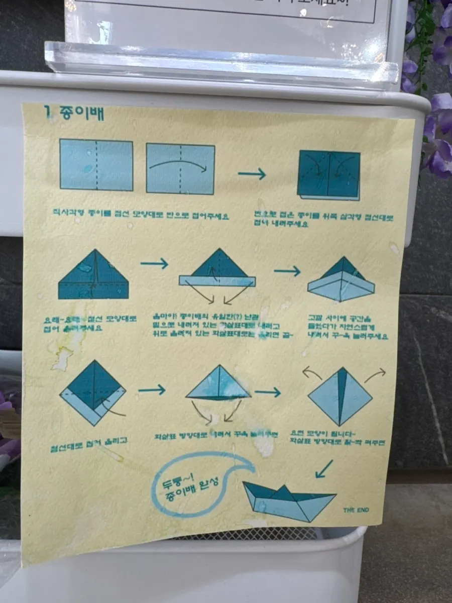Holding a hand-folded paper boat
