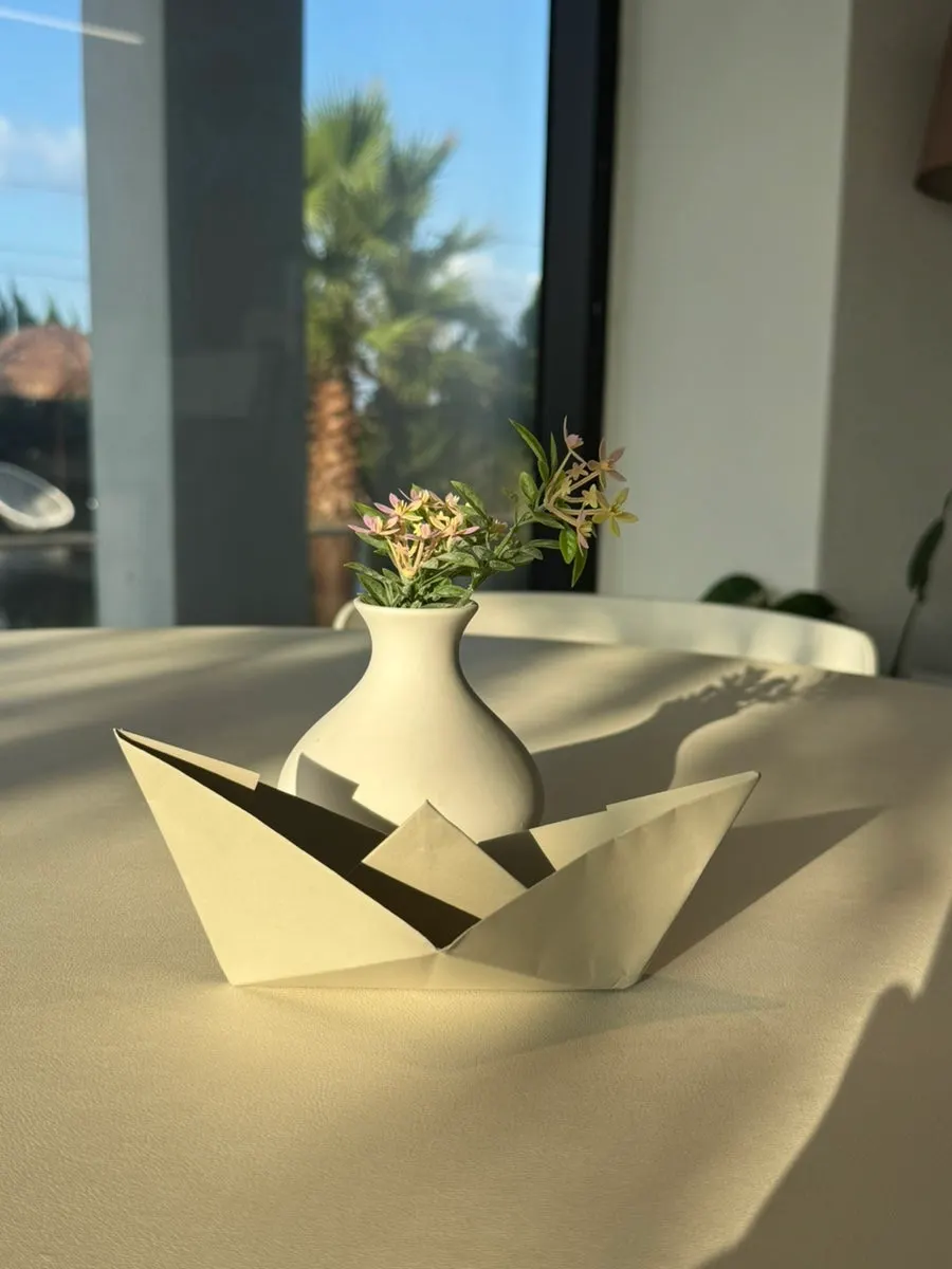 Colorful paper boats floating on the reflection pool