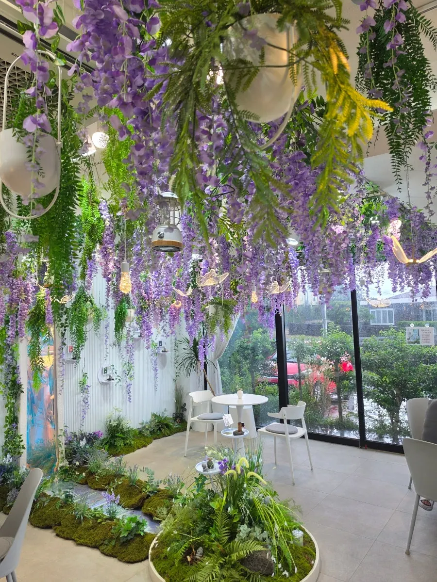 Purple flowers cascading down from the entrance