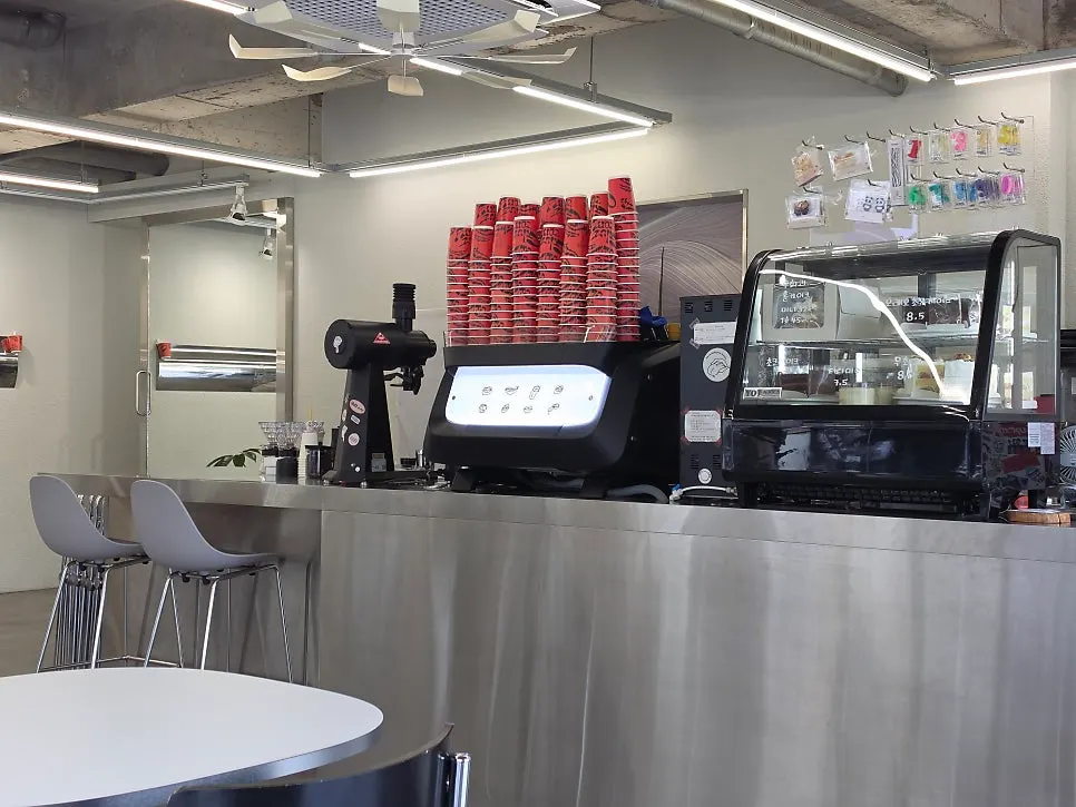 Interior of Gluttony Coffee arranged in clean white tones