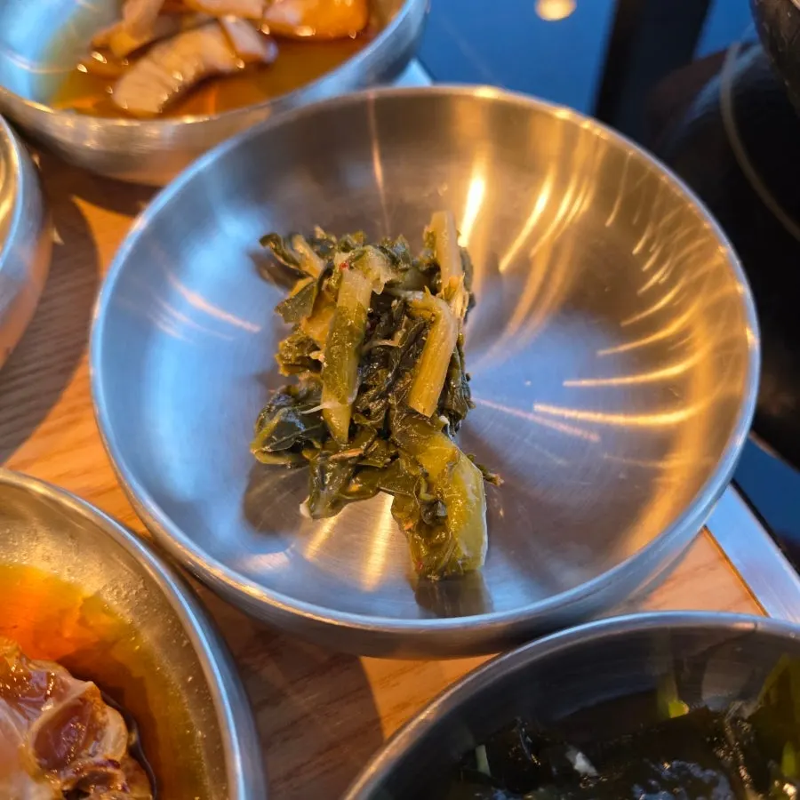 Side dishes served in stainless bowls