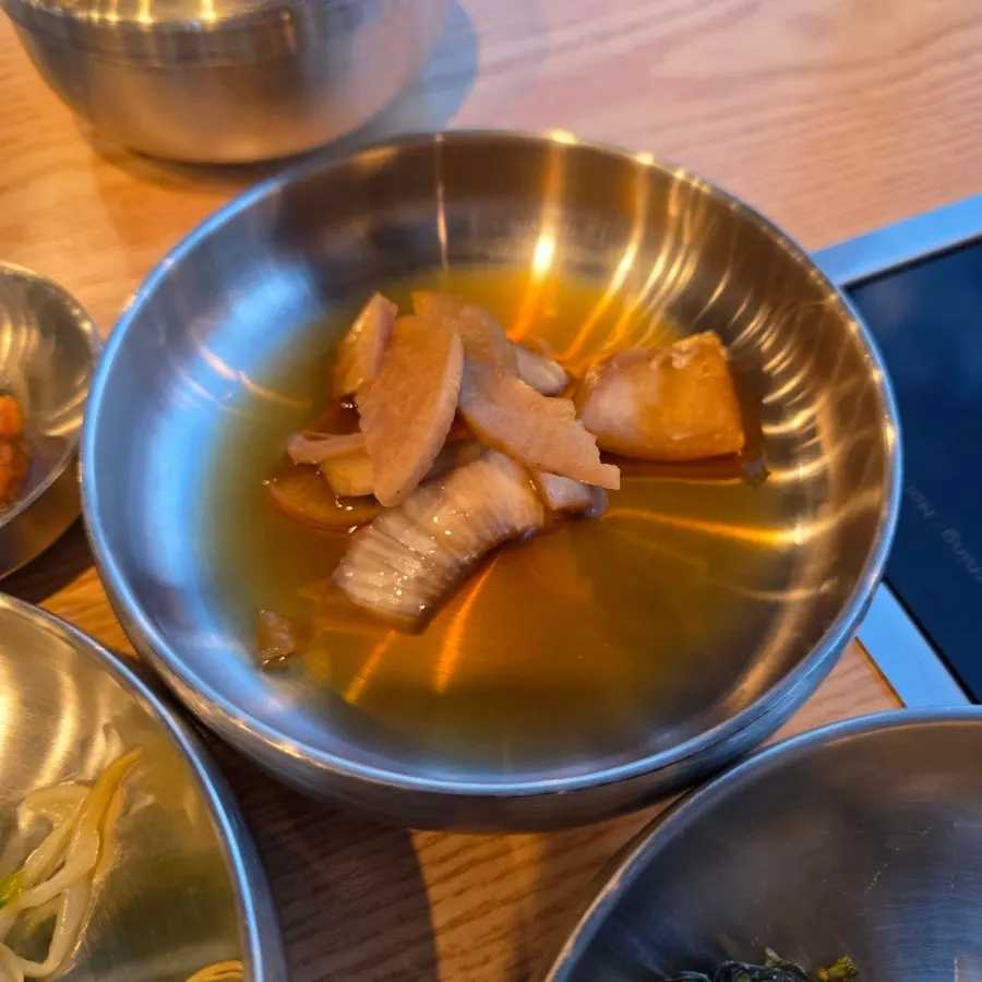 Jeju side dishes served in stainless bowls