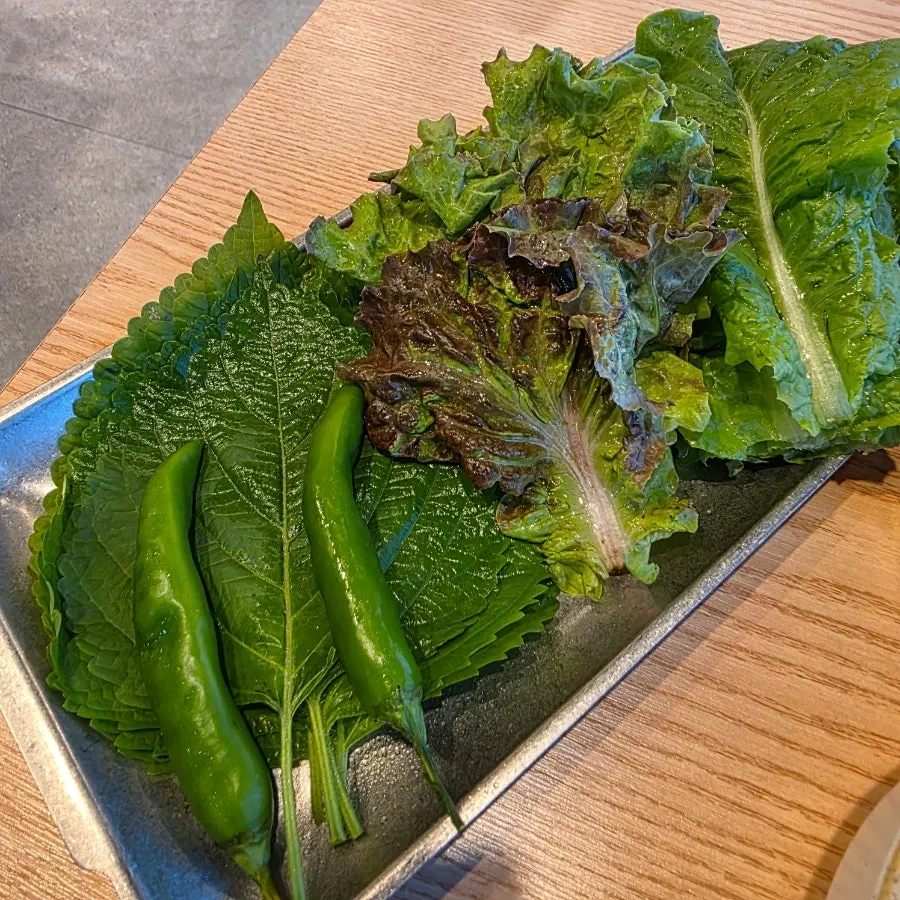 Plate with three kinds of wrap vegetables and chili peppers