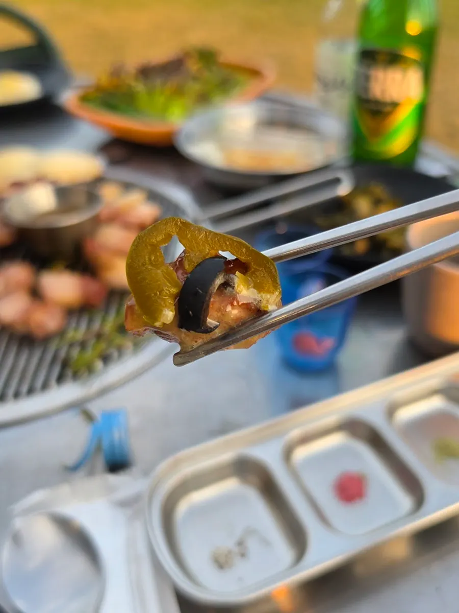 Whale-shaped soju cup turning red as soju is poured