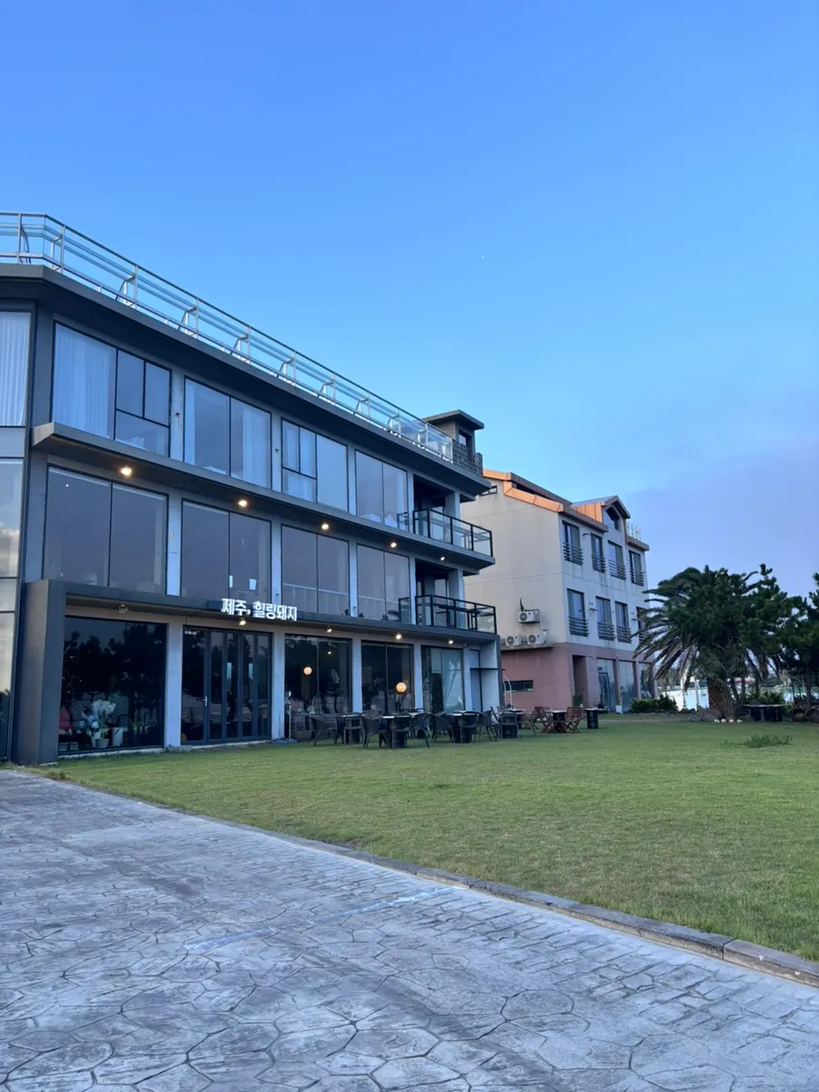 Exterior of Jeju Healing Dwaeji and the parking lot out front