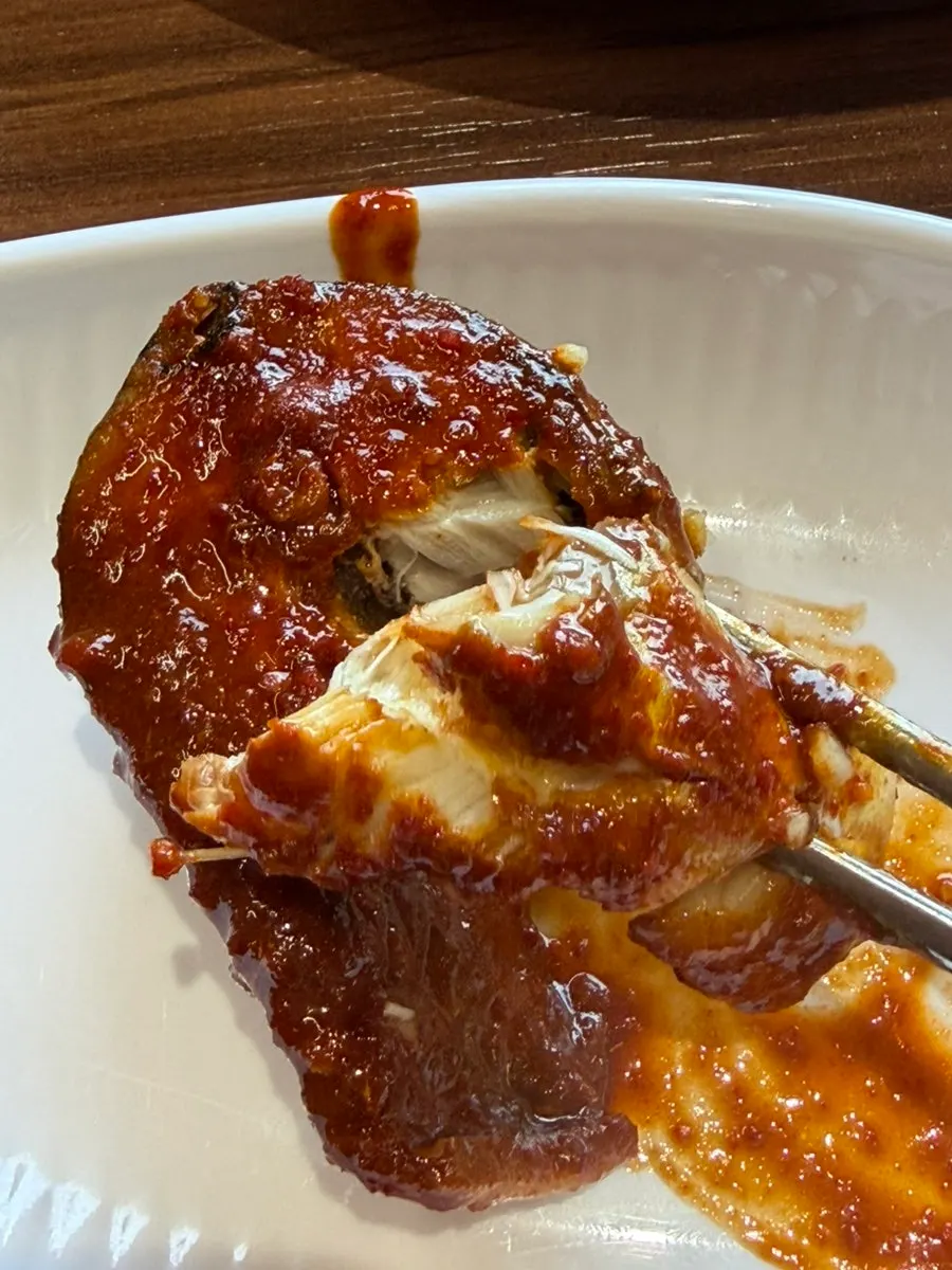 A piece of mackerel stew topped with sauce