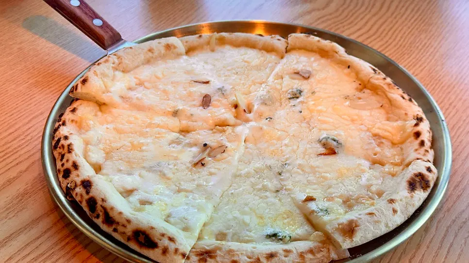 The wood-fired pizza served alongside the grilled fish set