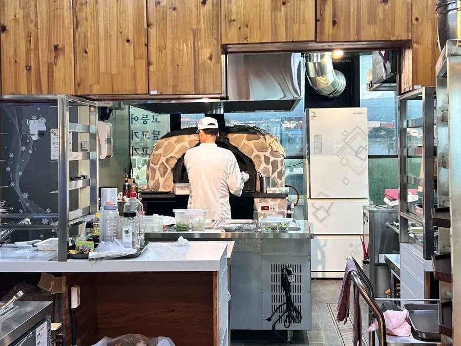 Kitchen area with the wood-fired oven for grilling fish