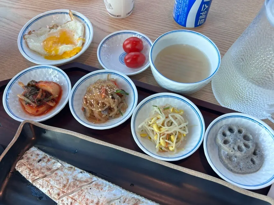 Four side dishes: chonggak kimchi, japchae, seasoned bean sprouts, braised lotus root