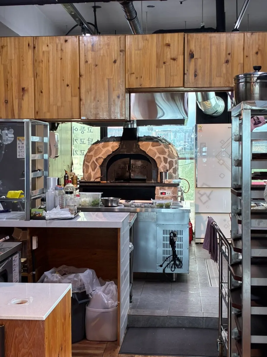 Interior view showing the wood-fired oven used to grill fish