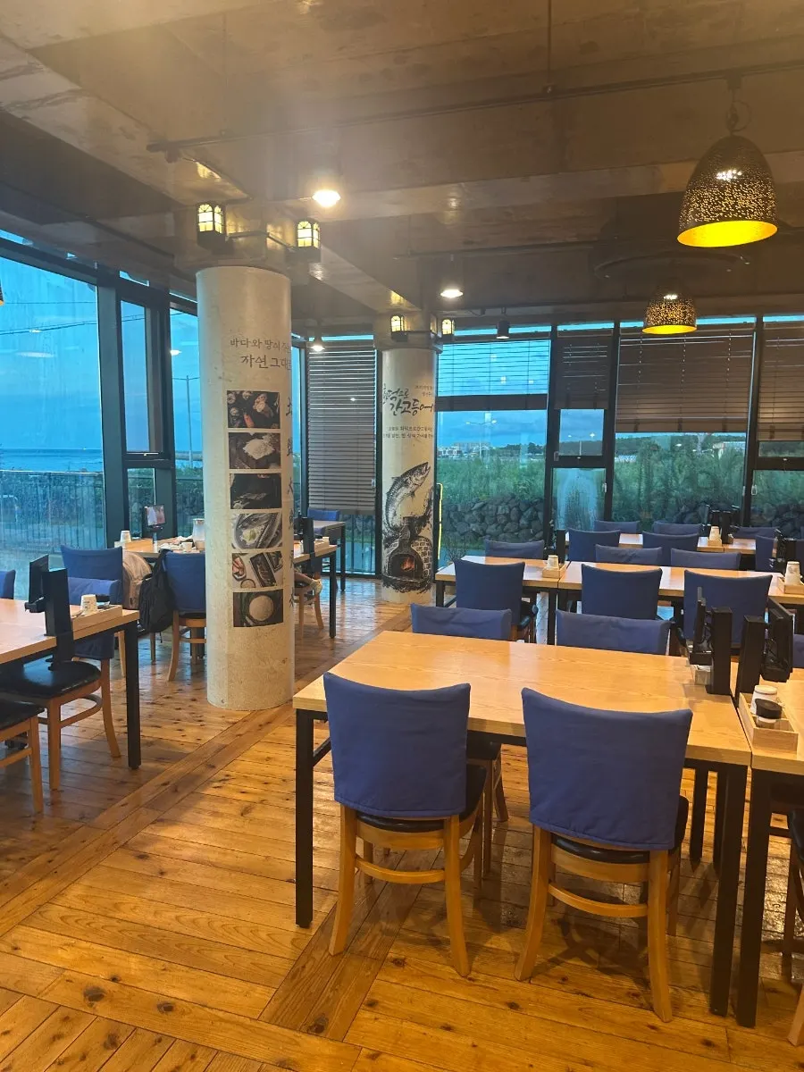 Seating with sunset visible through the glass windows