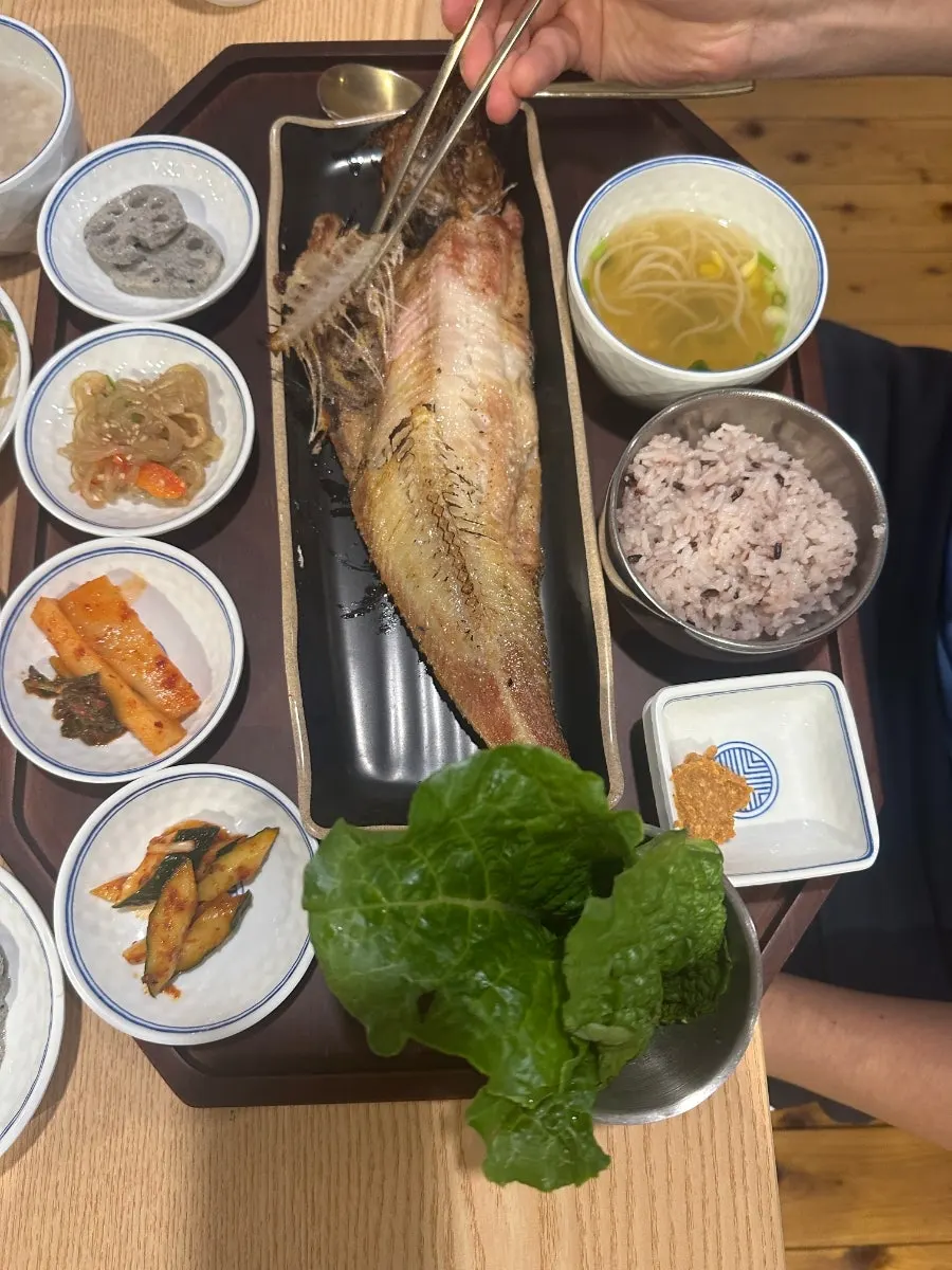 Fish and ssamjang piled onto a wrap green