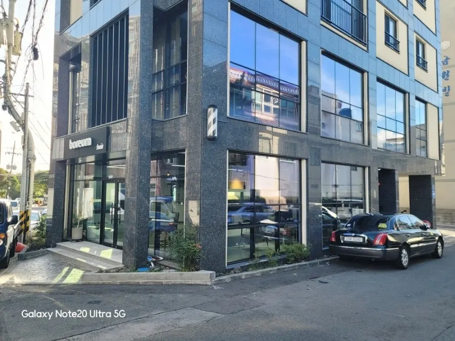 Sleek, clean exterior of the Boreum Hair Jeju Inje building