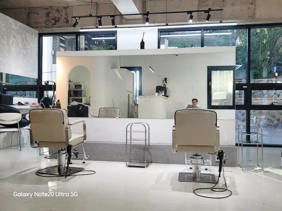 Mirrors and chairs arranged with generous spacing