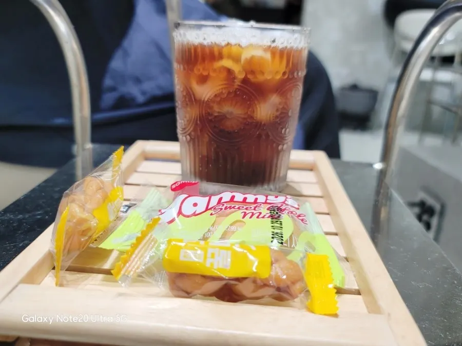A tray with iced Americano and snacks served during treatment