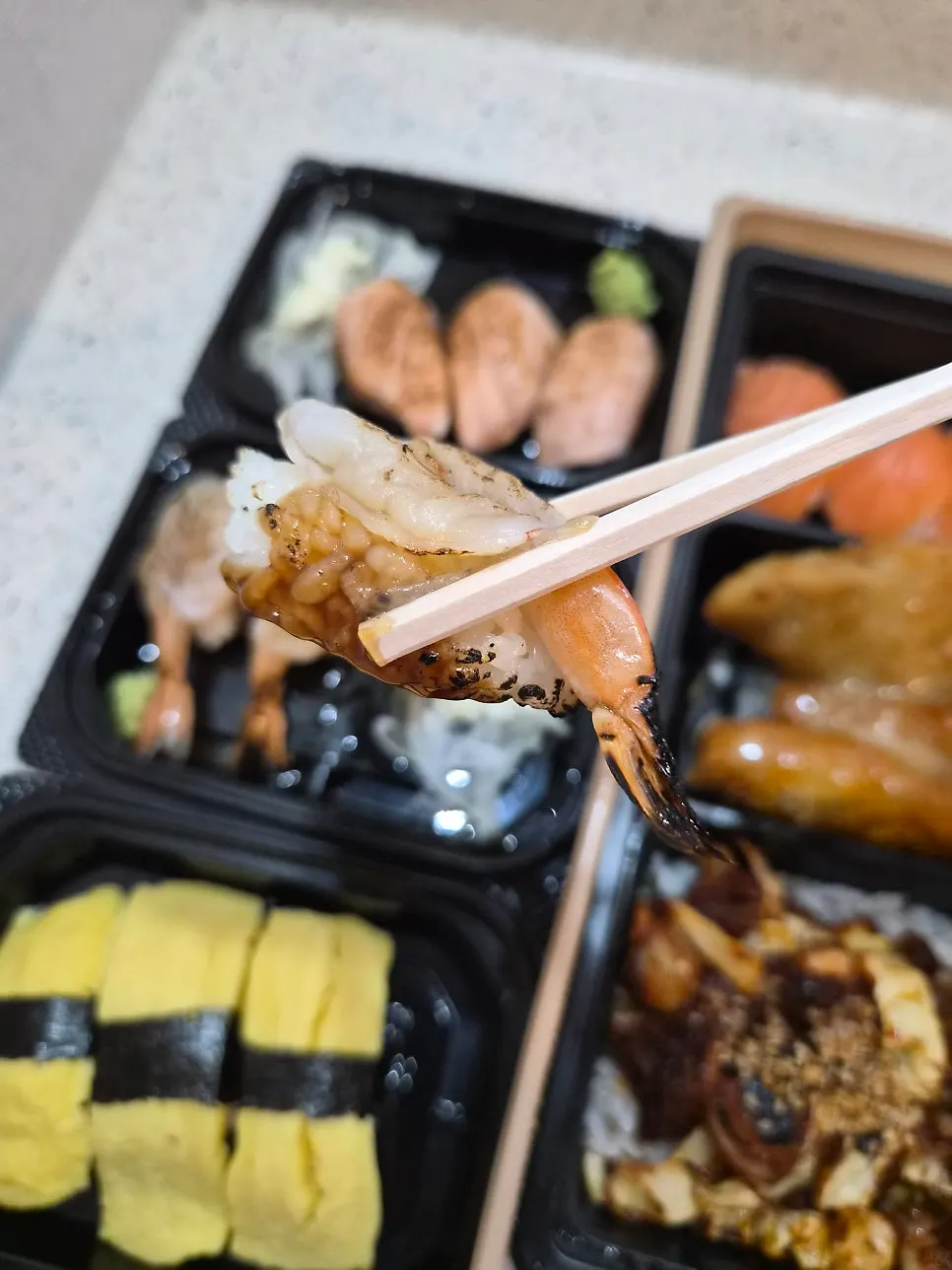 Grilled sushi being seared with a torch