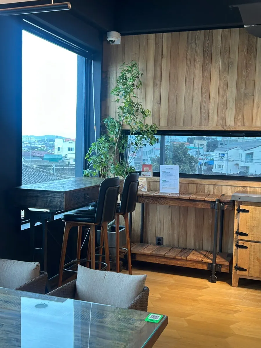 Seat with a view of the Jeju sea beyond the window