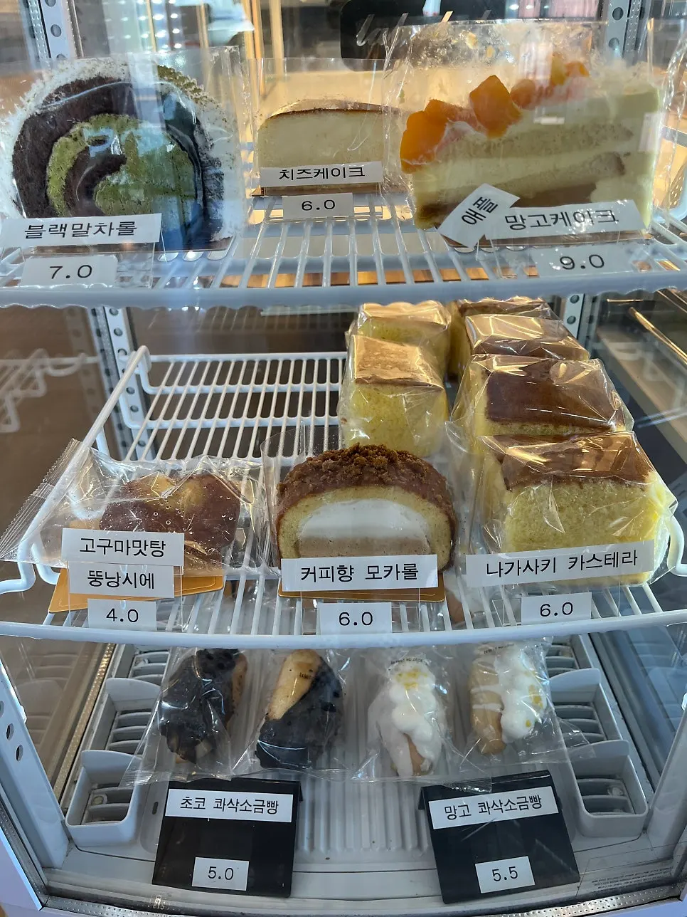 Dessert showcase with rolls and cakes