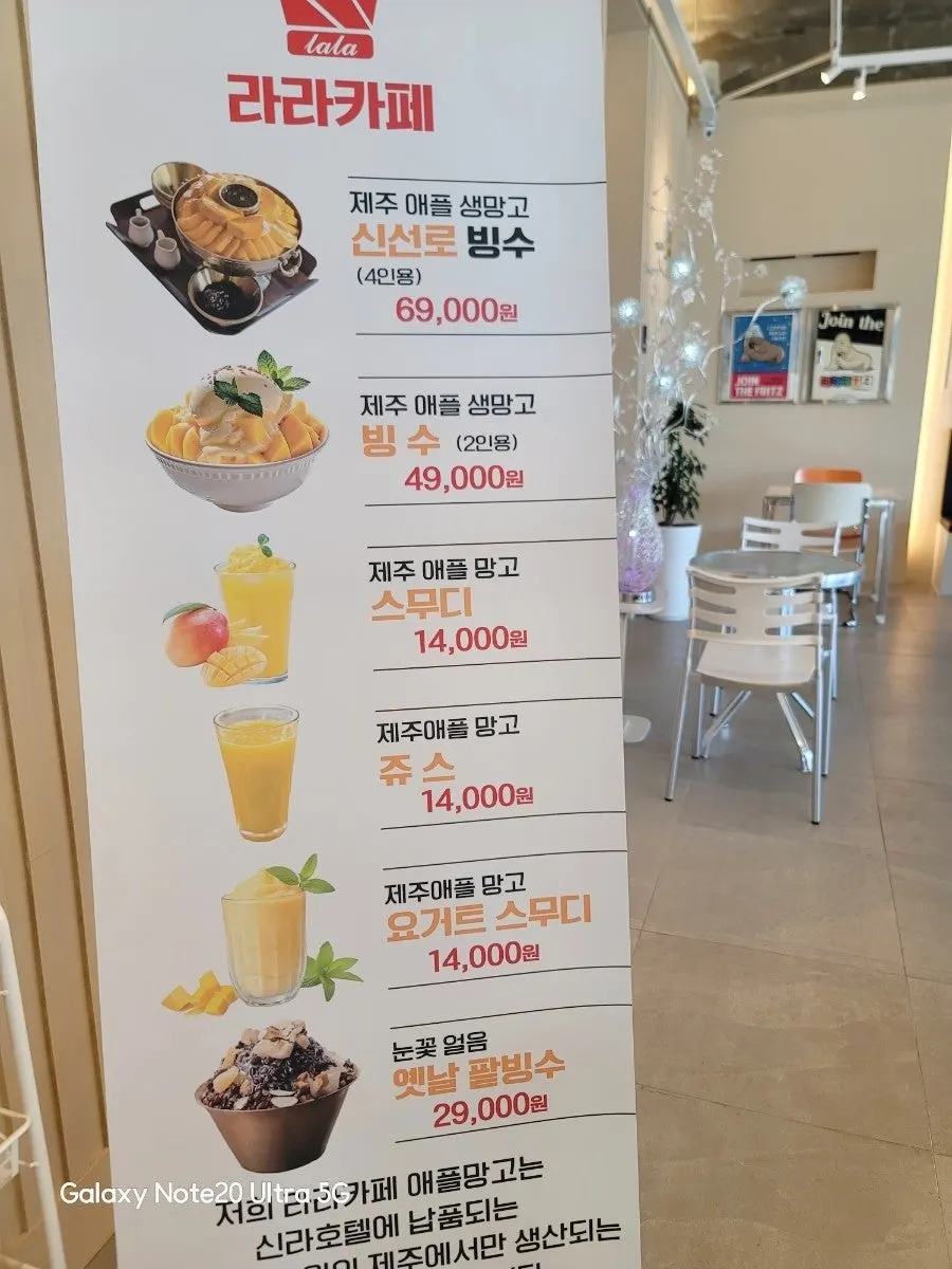 Lala Cafe's menu board listing mango items