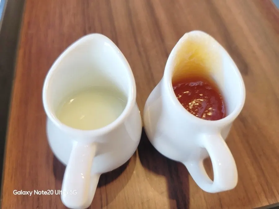 Mango sauce and condensed milk in a ceramic jug