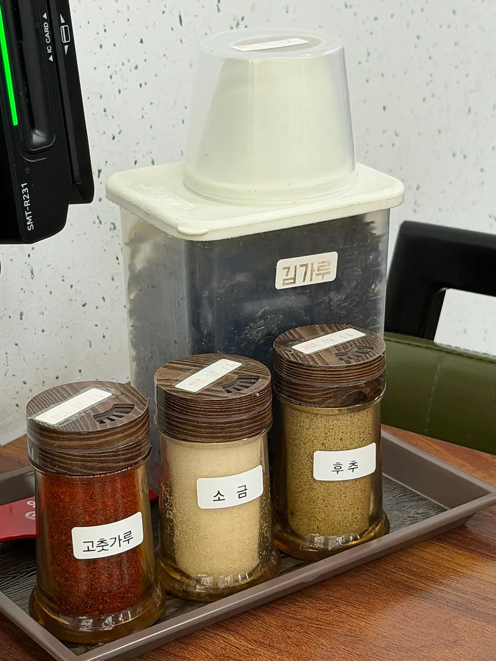 Red pepper flakes, salt, pepper, and seaweed flakes on the table