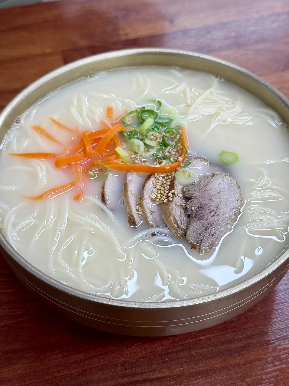 Close-up of Myeonjumak's rich bone broth pork noodle soup