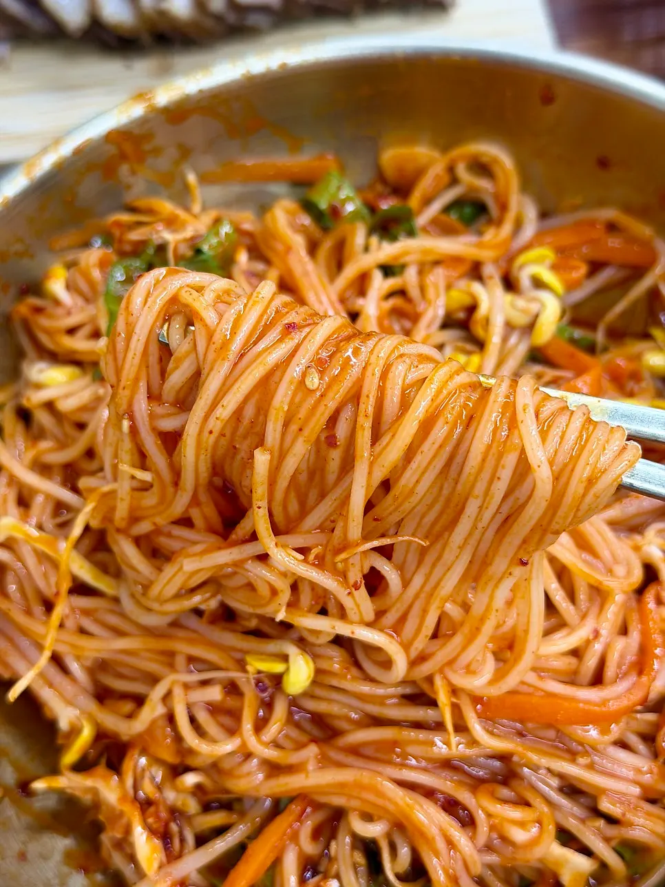 Sauce-coated noodles and black pork lifted together