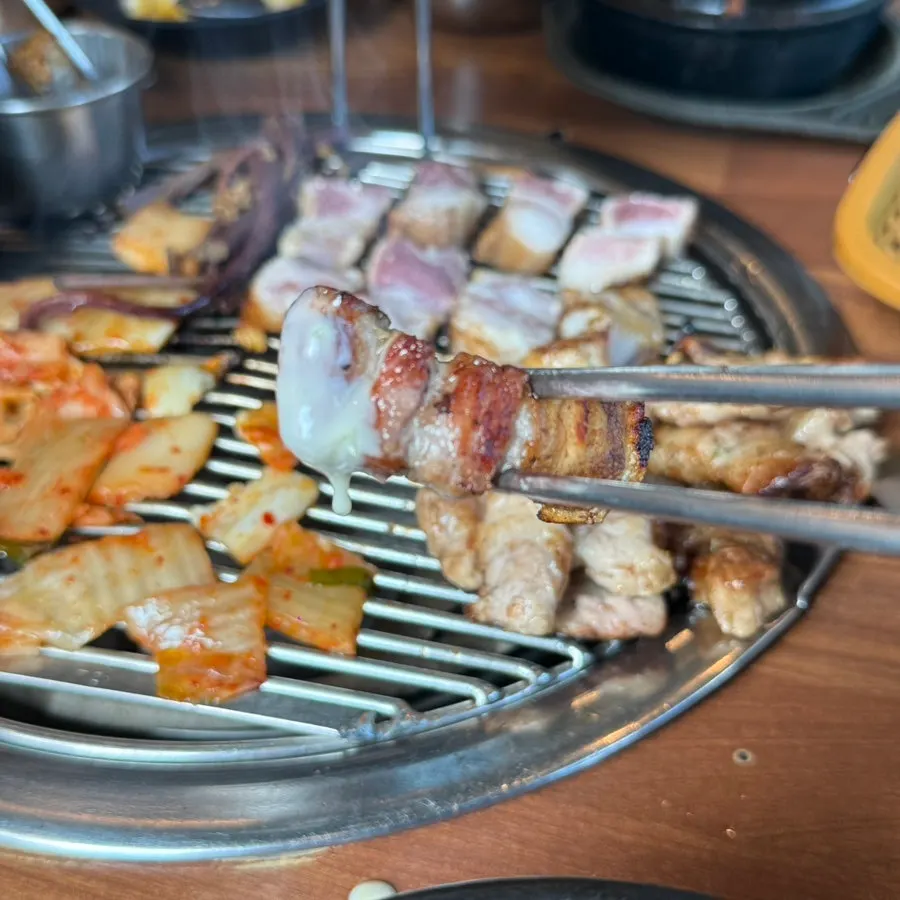 Pre-grilled black pork belly on the grill
