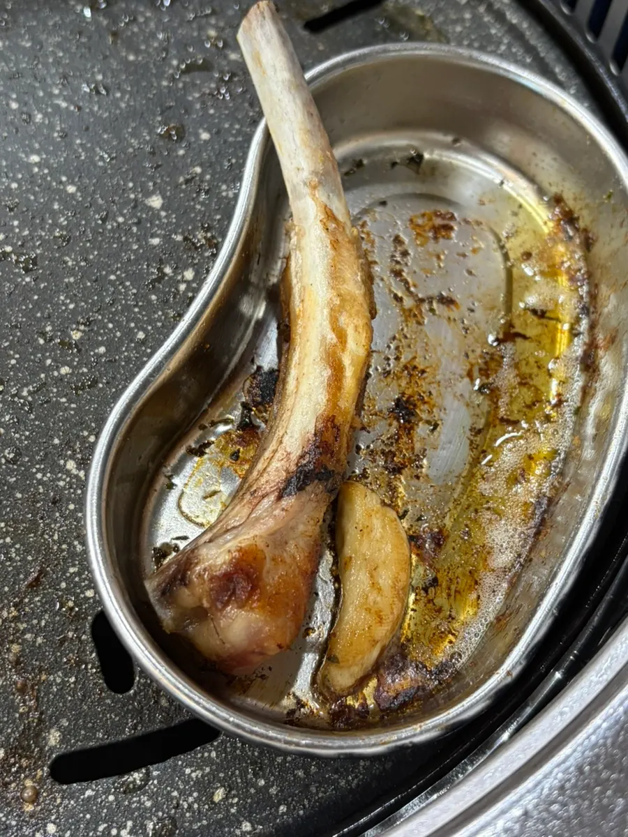 Black bone ribeye held and eaten by hand
