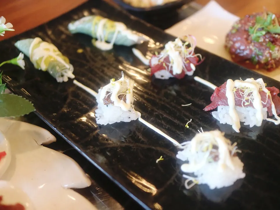 Horse meat sushi topped with sauce