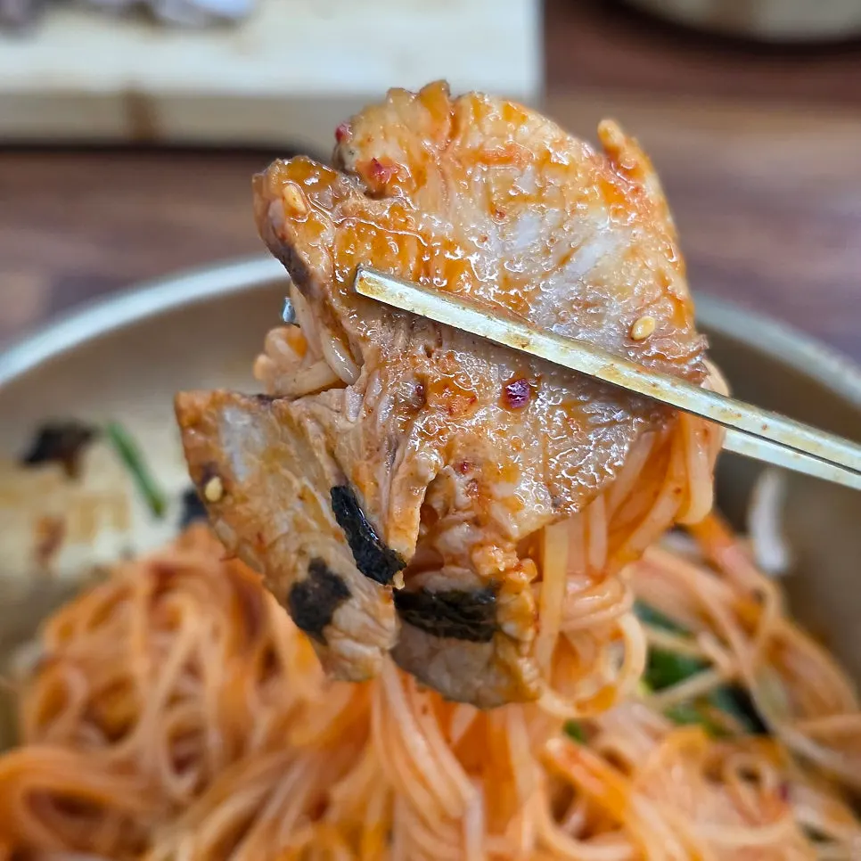 Spicy mixed pork noodles tossed in red sauce