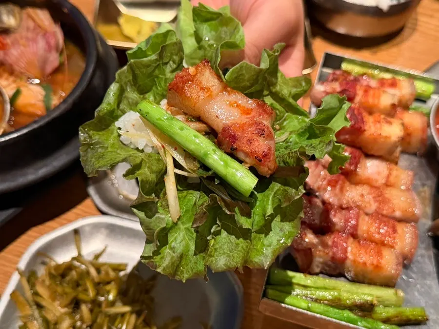 Black pork belly wrapped in lettuce