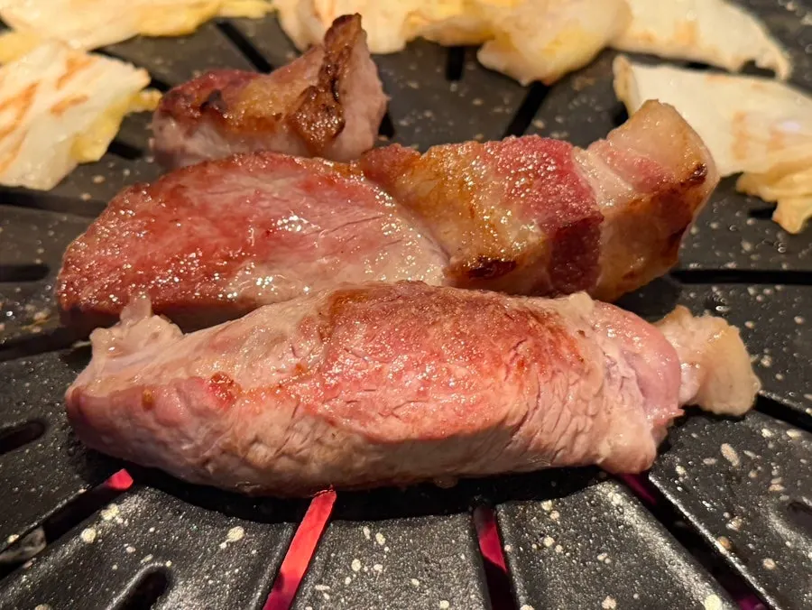 Black pork shoulder placed on the grill