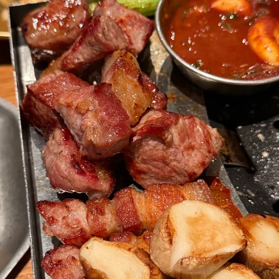 A large chunk of grilled black pork shoulder