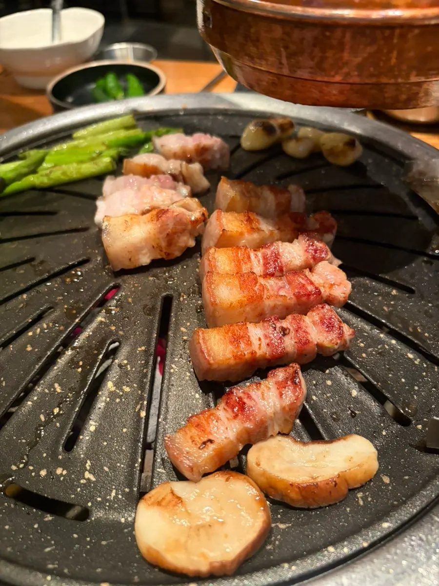 Jeju black pork ogyeopsal grilling over charcoal