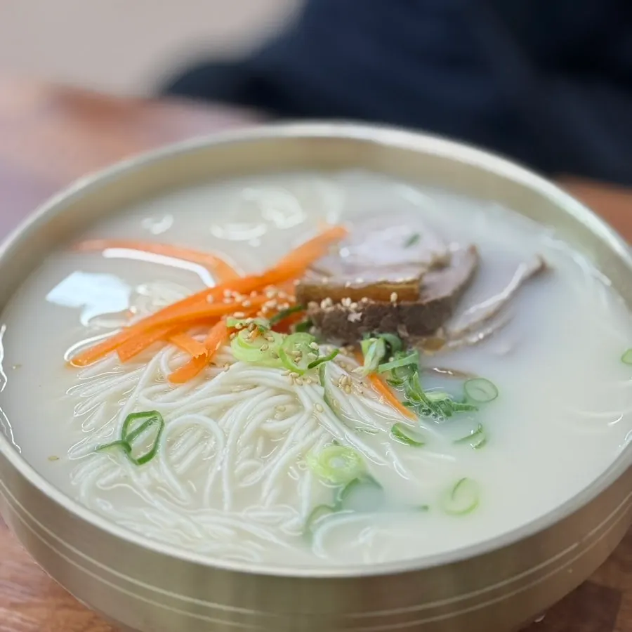 Double portion of Jeju black pork noodles in milky broth