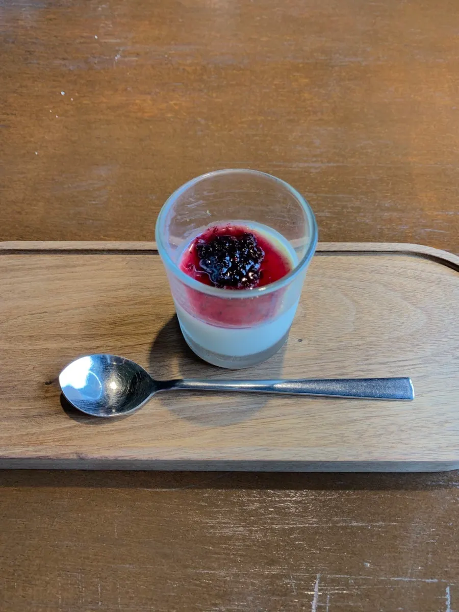 Panna cotta topped with berries and cookie crumble