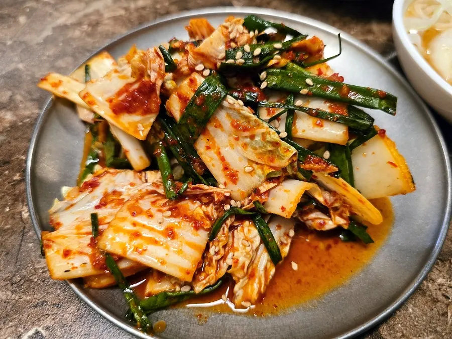 Close-up of side dish plates at Pork80
