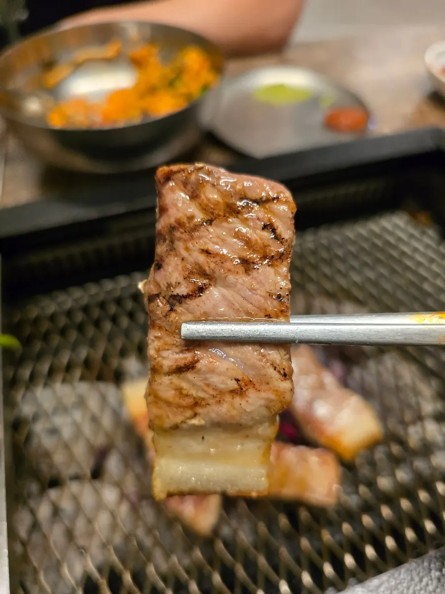Grilling the remaining meat on the grate